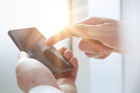 Young man writes an SMS to your mobile phone