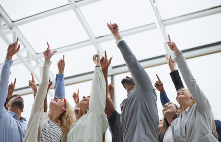 multi-ethnic men and women raise their hands,の写真素材