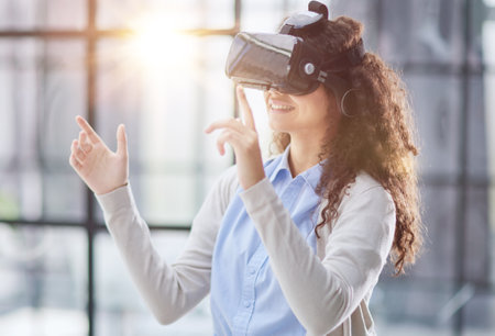 positive woman wearing virtual reality goggles headsetConnection, technology, new generation,...