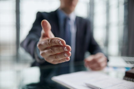 Close up agent reach out hand to camera handshake client.の写真素材