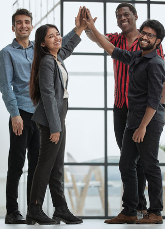 Teamwork - business people with joint hands in the officeの写真素材