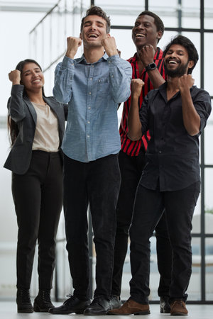 Happy businessmen raise their fists up and laugh. They have trainingの写真素材