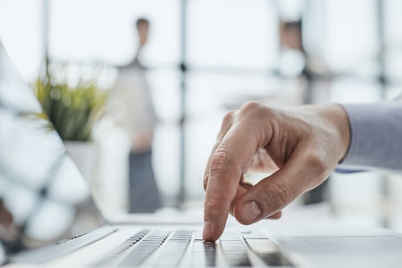 Man hands typing on laptop computer keyboard, close up.の写真素材