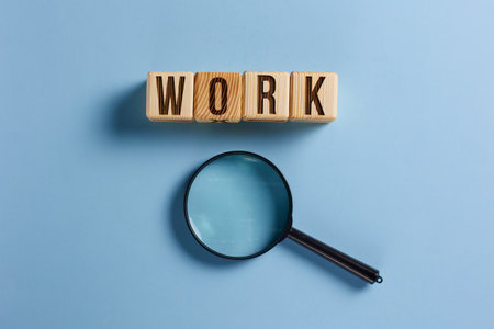 The word work is inscribed in wooden cubes. blue background.の写真素材