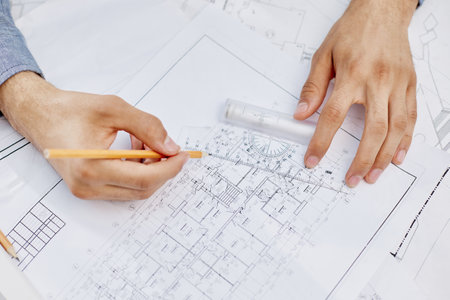 Young handsome architect engineer working on design plan