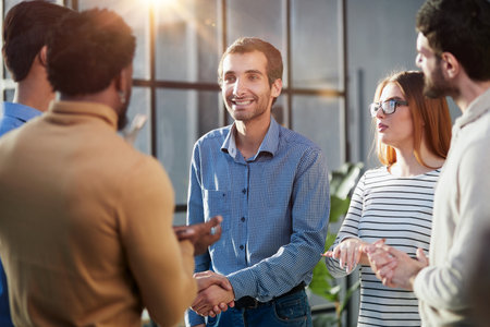 Two happy diverse professional business men executive leaders shaking hands at office meeting.の写真素材