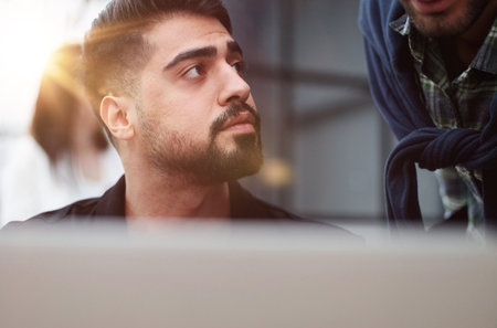 Support. Portrait of a young businessman in casual clothes talking with a colleagueの写真素材