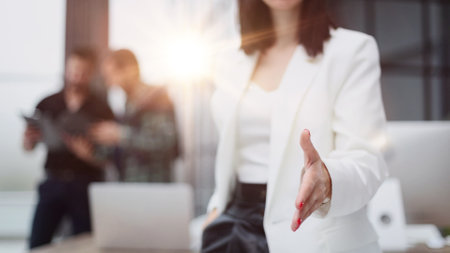 young business woman greets a colleague with a handshake.の写真素材
