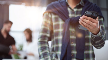 Close-up of male hands using a mobile phone or smartphone.の写真素材