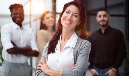 close-up of a young woman in the office on the background of colleaguesの写真素材