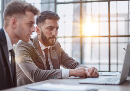 Two happy men working together on a new business projectの写真素材