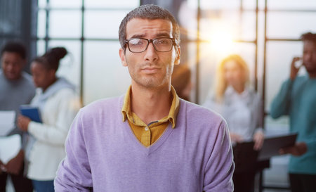 Young handsome man in elegant clothes and glasses looks away