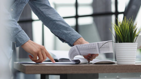 businessman reviewing document reports at office workplaceの写真素材