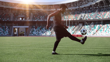 African American man playing football on the stadium field. A man runs with a soccer ball across the field.の写真素材