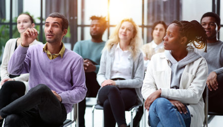 young people shaking hands in a circle of like-minded people