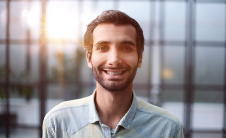Confident young smiling businessman posing on cameraの写真素材