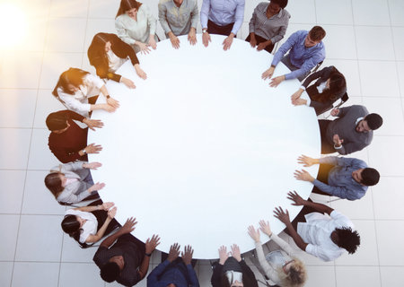 Top view of group of multiethnic busy people working in office, aerial view of sitting at negotiating table, business meeting conceptの写真素材
