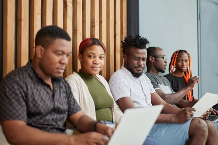 Business people waiting for job interview. Five candidates competing for one positionの写真素材