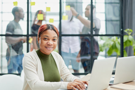 Cropped shot of an attractive young businesswoman working in her office.の写真素材