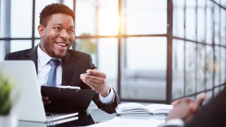 man working inside office using laptop at work, satisfied with achievement resultの写真素材