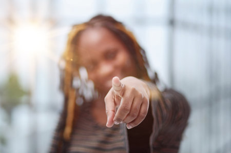 African young woman wearing pointing fingers to camera