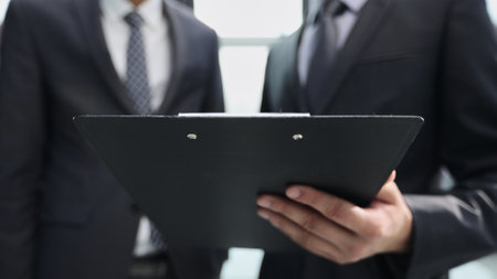 Two Businessmen Having Informal Meeting In Modern Officeの写真素材