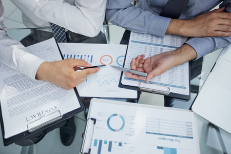 two businessmen watching a growth chart close-upの写真素材