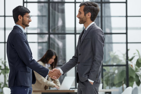Let me take a look. Full length shot of two corporate businessmen meeting in the boardroom.の写真素材