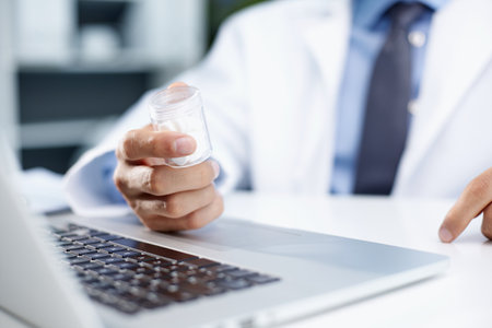 caucasian man doctor holding bottle of pillsの写真素材