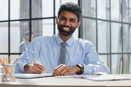 male investor beard looking at camera and smiling in modern office