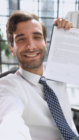 man in white shirt showing contract close upの写真素材