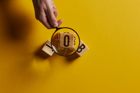 Magnifying glass on word work on yellow backgroundの写真素材
