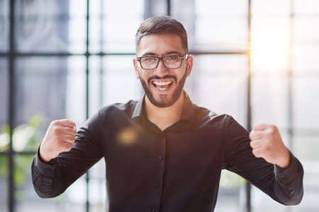 Portrait of a cheerful businessman celebrating his successの写真素材