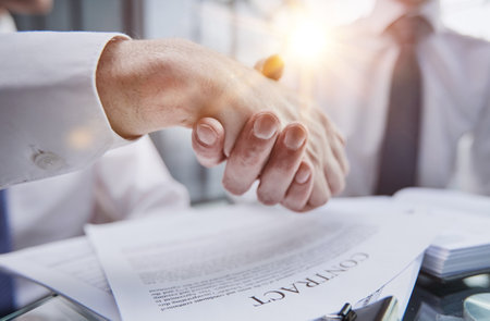 Close up businessman shaking hands with caucasian client.の写真素材