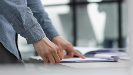 businessman reviewing document reports at office workplaceの写真素材