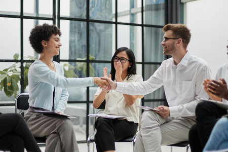 young confident business people joining forces in the officeの写真素材