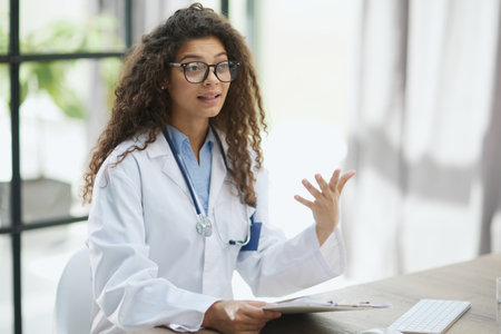 Closeup portrait, woman healthcare professional with stethoscope enjoying readingの写真素材