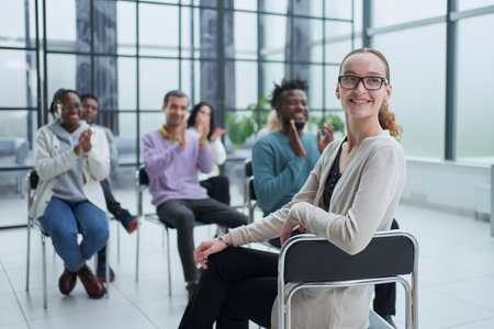 Partial view of business people listening to mentor during business training in officeの写真素材