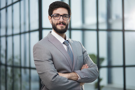 Portrait of serious handsome successful businessman in glasses and suit.の写真素材