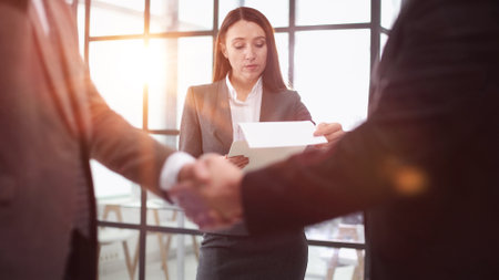mature workers shaking hands in partnership deal, collaboration
