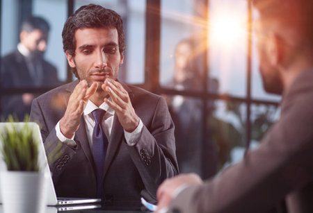 Focused stylish millennial businessman consulting expert at the tableの写真素材