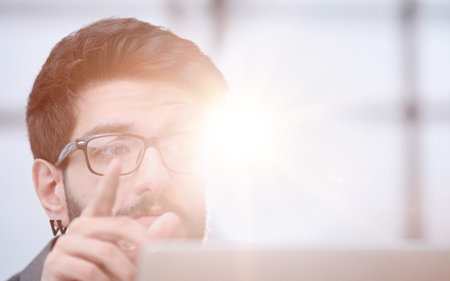 Businessman using a laptop while working late in his officeの写真素材