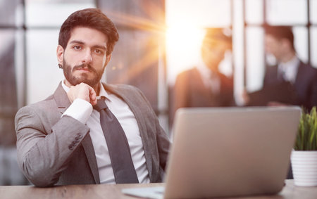 Young thoughtful business man executive manager wearing suit working in modern officeの写真素材