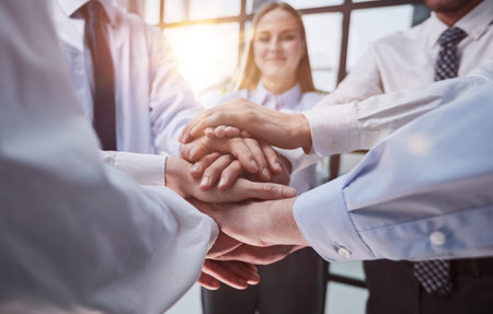 Close up on colleagues hands all together