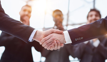 close-up of a handshake of business partners against the backgroの写真素材
