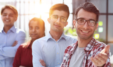 Welcome on board. Portrait of positive confident millennial male hr manager leader of multiethnic teamの写真素材