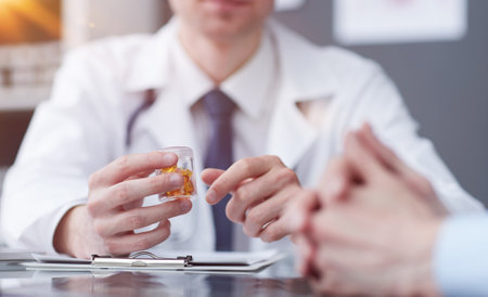 doctor pointing his finger at the pills at the tableの写真素材