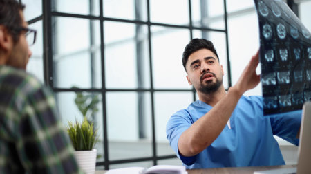 Cheerful male patient and doctor shaking hands.の写真素材
