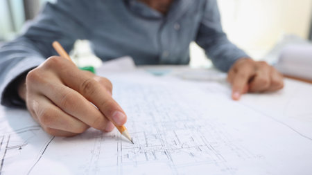 A close-up of male architect working on a project of a residential building