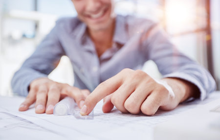 Young handsome architect engineer working on design planの写真素材